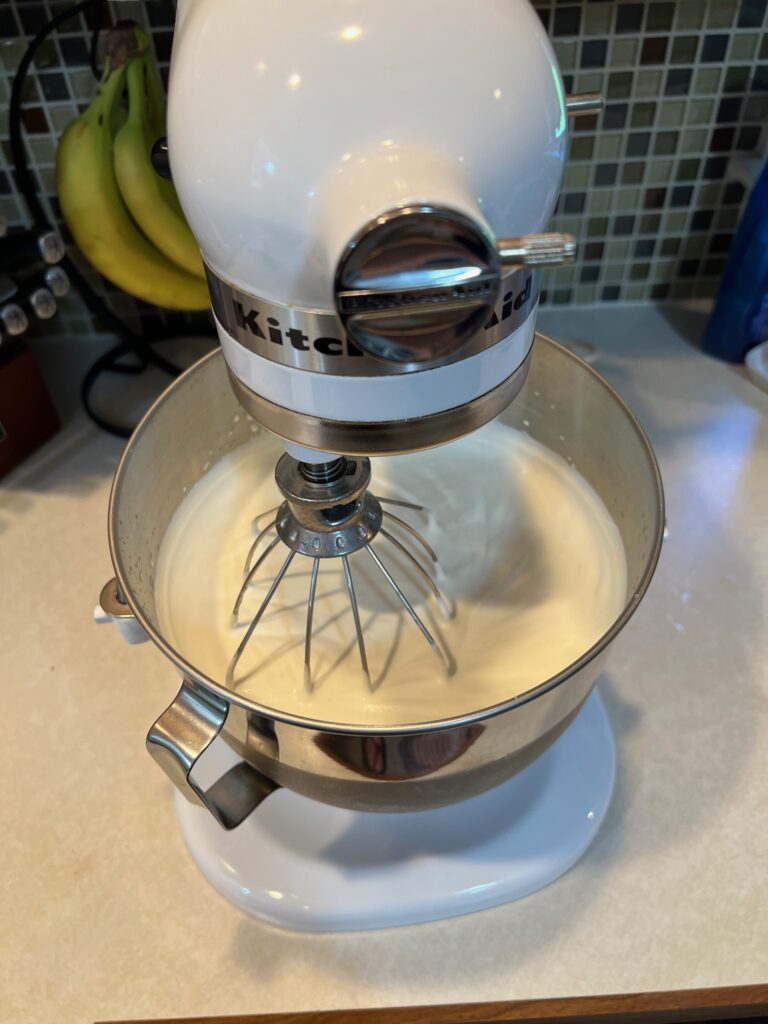 Heavy cream in a white stand up mixer