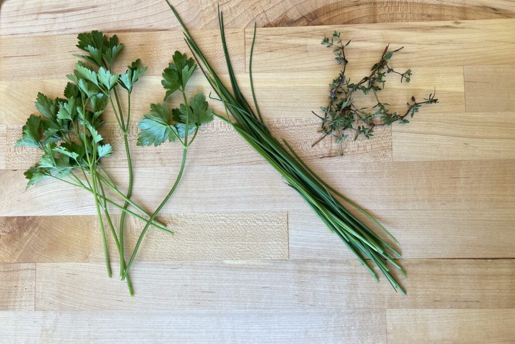 Fresh herbs on a wooden cutting board