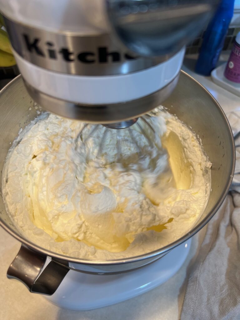 homemade whipped cream in a white stand up mixer