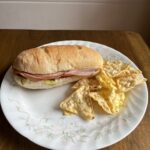 Homemade grinder on a white plate with chips