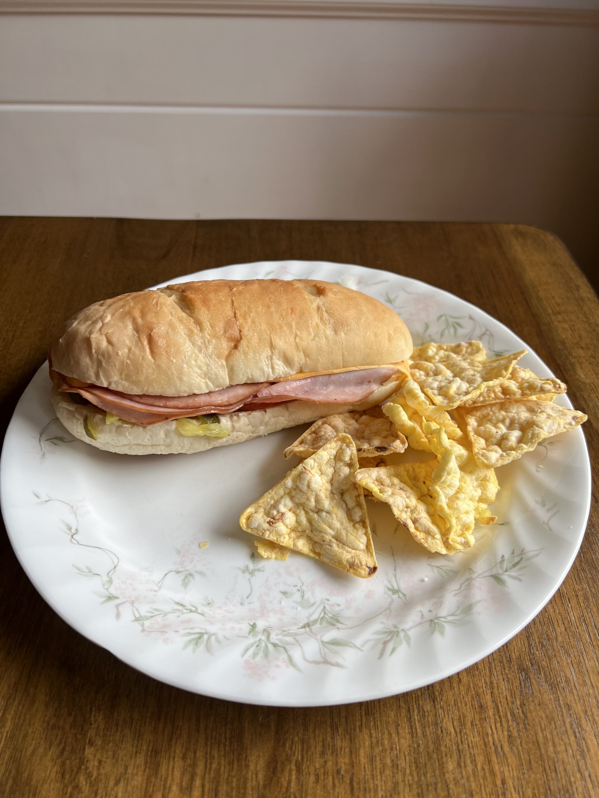 Homemade grinder on a white plate with chips