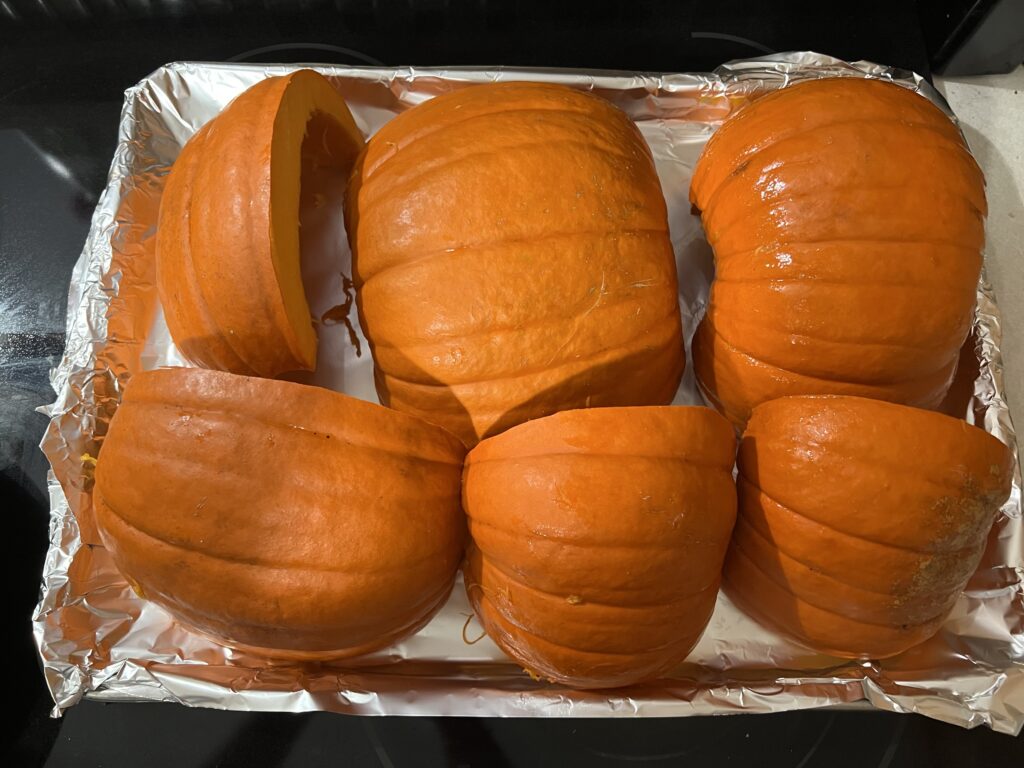  Pumpkins cut in half on a baking tray