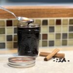 The best homemade elderberry syrup with spoon sitting on the counter